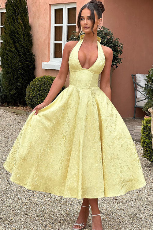 Romantic floral print midi dress for wedding guests, featuring a halter neck and flattering corset.