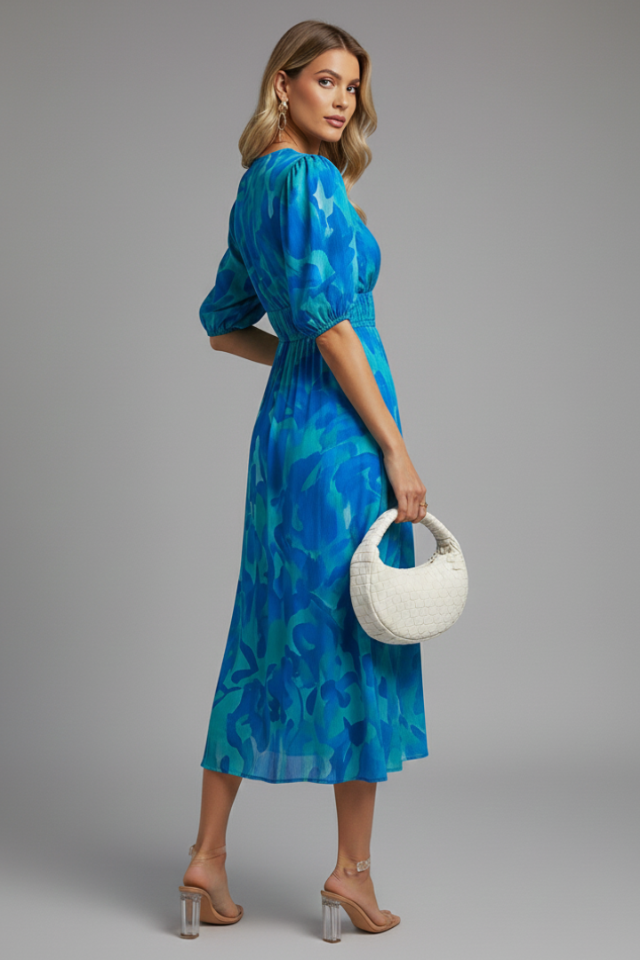 Feminine elegant floral midi dress for women, designed with trendy puff sleeves for ultimate summer style.