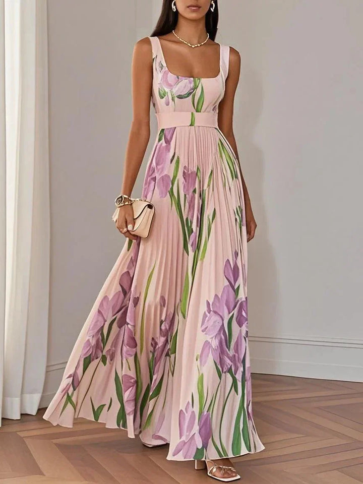 Beautiful summer floral pleated maxi dress with a square neckline for women. Elegant party or wedding guest attire.