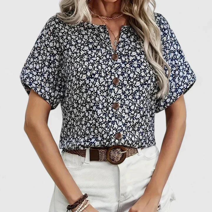 Flowy women's blouse with vibrant floral print. Elegant & comfortable, perfect for everyday or office wear.