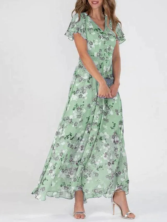 Flowy floral maxi dress for women, featuring a flattering V-neck and delicate flutter sleeves. Comfortable summer wear.