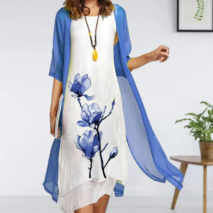 Women's two-piece floral print midi dress and sheer cardigan set, an elegant layered look for warm weather.