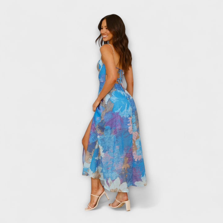Close-up of elegant women's floral print midi dress, showcasing vibrant pattern. Perfect for summer events & parties.