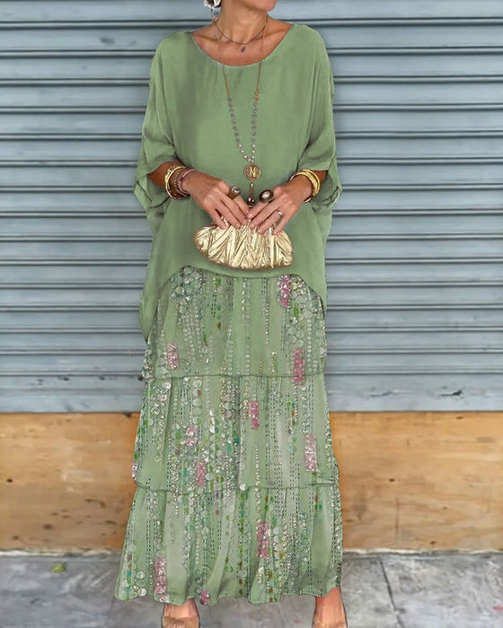 Flowing bohemian floral sequin tiered maxi dress, ideal as a wedding guest or chic party dress.
