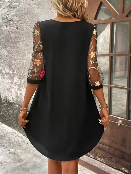 Feminine floral print V-neck cocktail dress featuring stylish sheer statement sleeves, ideal for evening events.