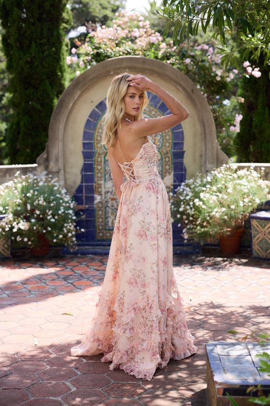 Stylish V-neck ruffle maxi dress in a charming blush floral print, a sophisticated wedding guest option.