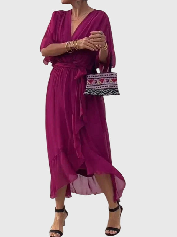Full-length women's elegant flowy maxi dress. V-neck, A-line cut, ideal for versatile occasion wear.