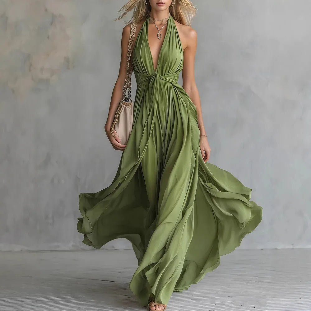Women's elegant flowy maxi dress in a backless style with delicate pleats and a sophisticated halter neck.
