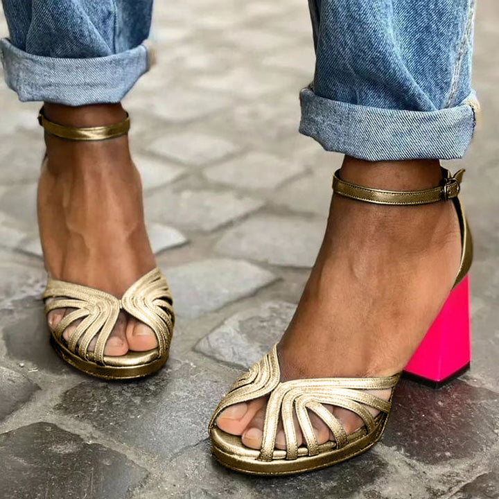 Elegant women's gold block heel sandals with an adjustable ankle strap and open toe, perfect for versatile summer style.