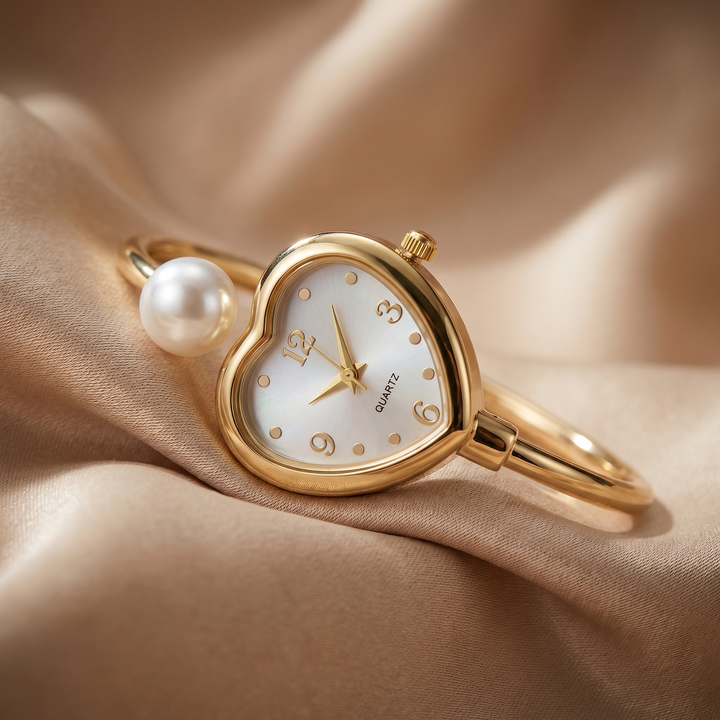 Stylish women's gold quartz watch. Features a classic round dial and a delicate bracelet with heart & pearl details.