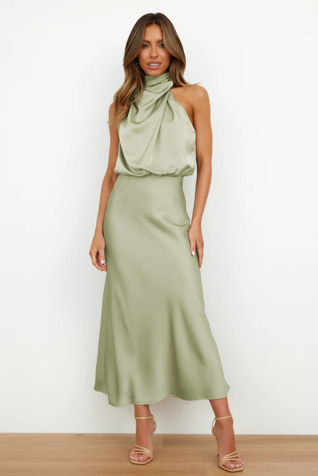 Elegant women's halter evening gown with open back, flowing floor-length skirt, perfect for formal events & galas.