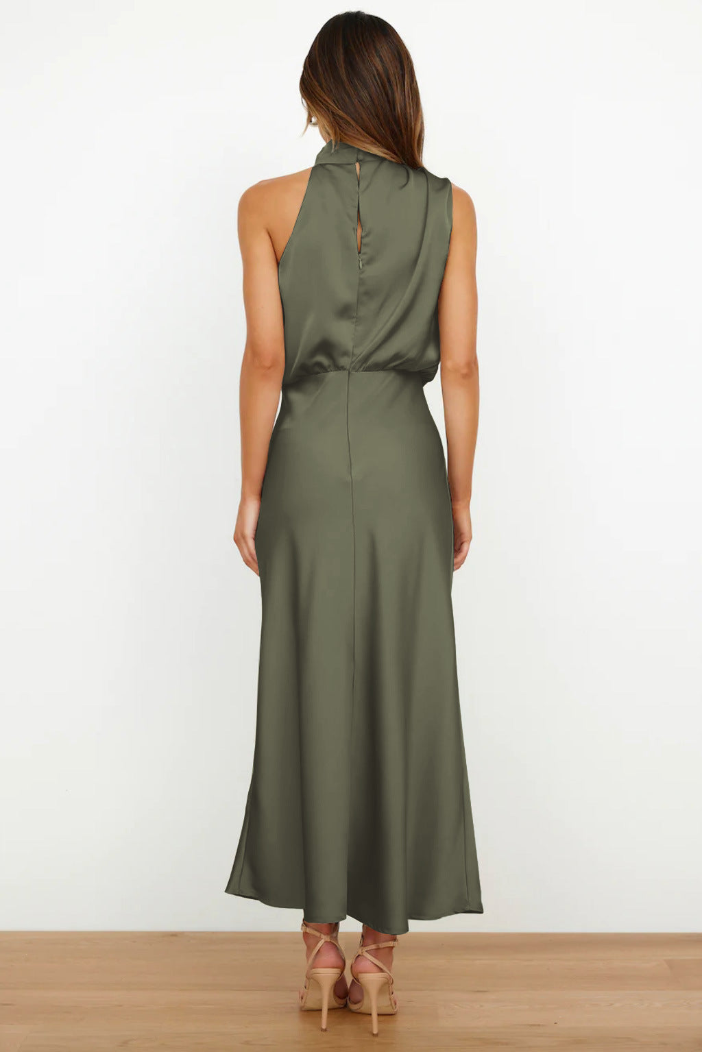Chic women's long halter dress, open back, flowing floor-length, sophisticated for special occasion wear.