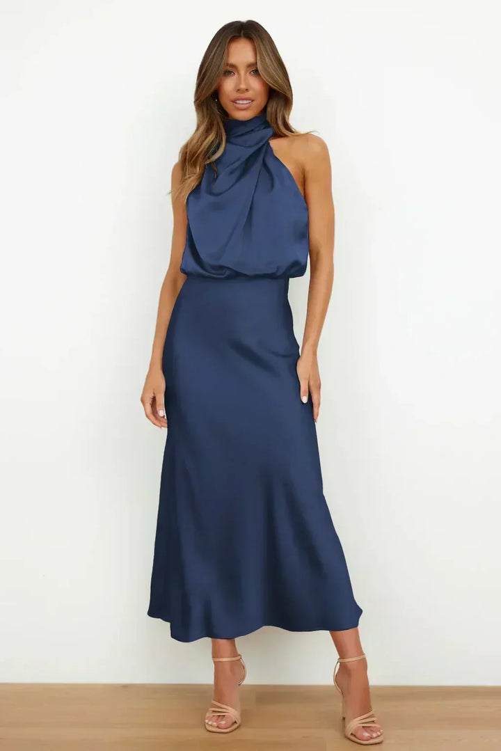 Comfortable flowing women's halter gown, open back, floor-length, elegant for evening & formal wear.
