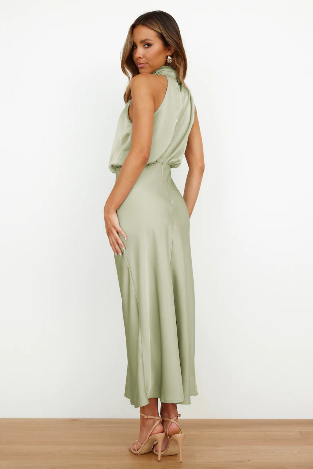 Stunning women's open-back halter evening gown, floor-length, flowing skirt, ideal for formal parties.