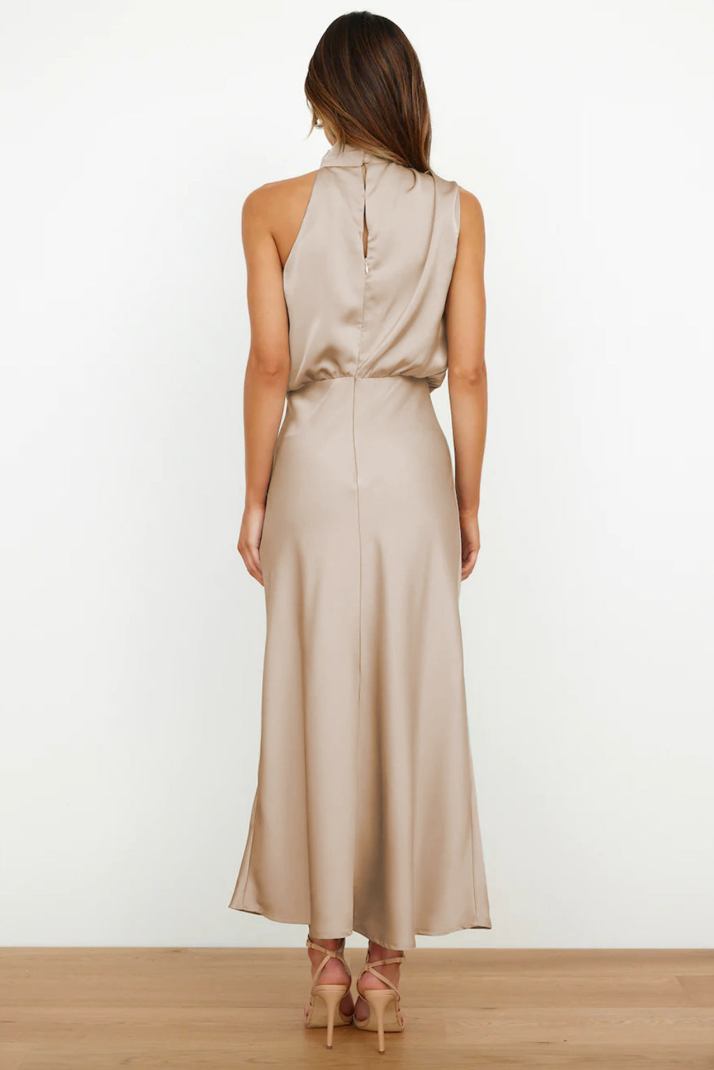 Luxurious women's halter evening gown, open back, flowing silhouette, formal wear, long party dress.