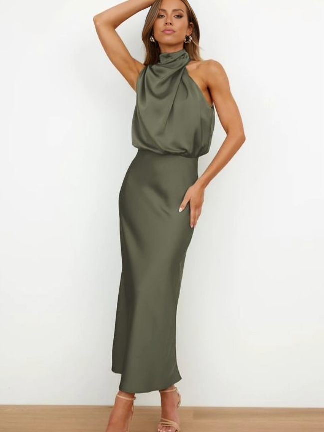Sleek halter neck women's evening gown, open back, long flowing skirt, ideal formal party dress.
