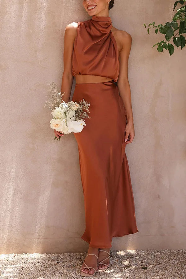 Elegant women's halter neck crop top & maxi skirt 2-piece set. Sophisticated evening outfit.