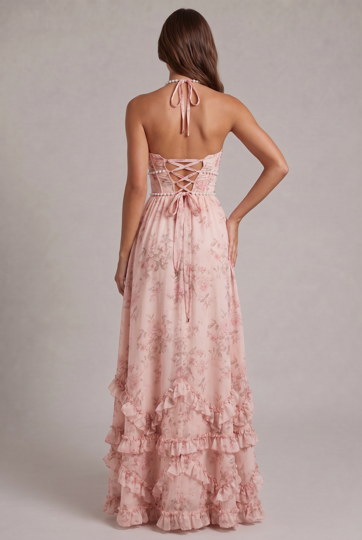 Flowy women's summer halter dress with a beautiful floral print, perfect for beach or evening wear.