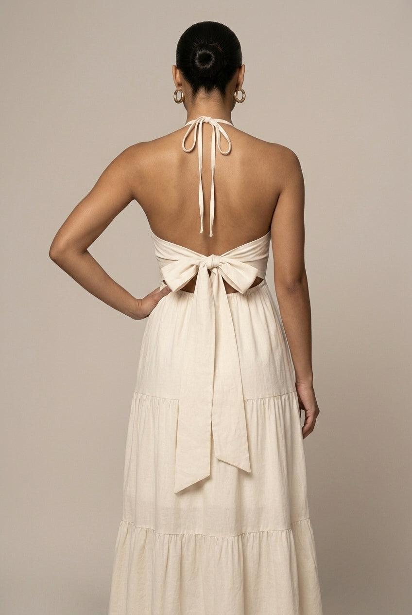 Chic women's halter neck maxi sundress, featuring a tiered ruffle skirt and stylish open back.
