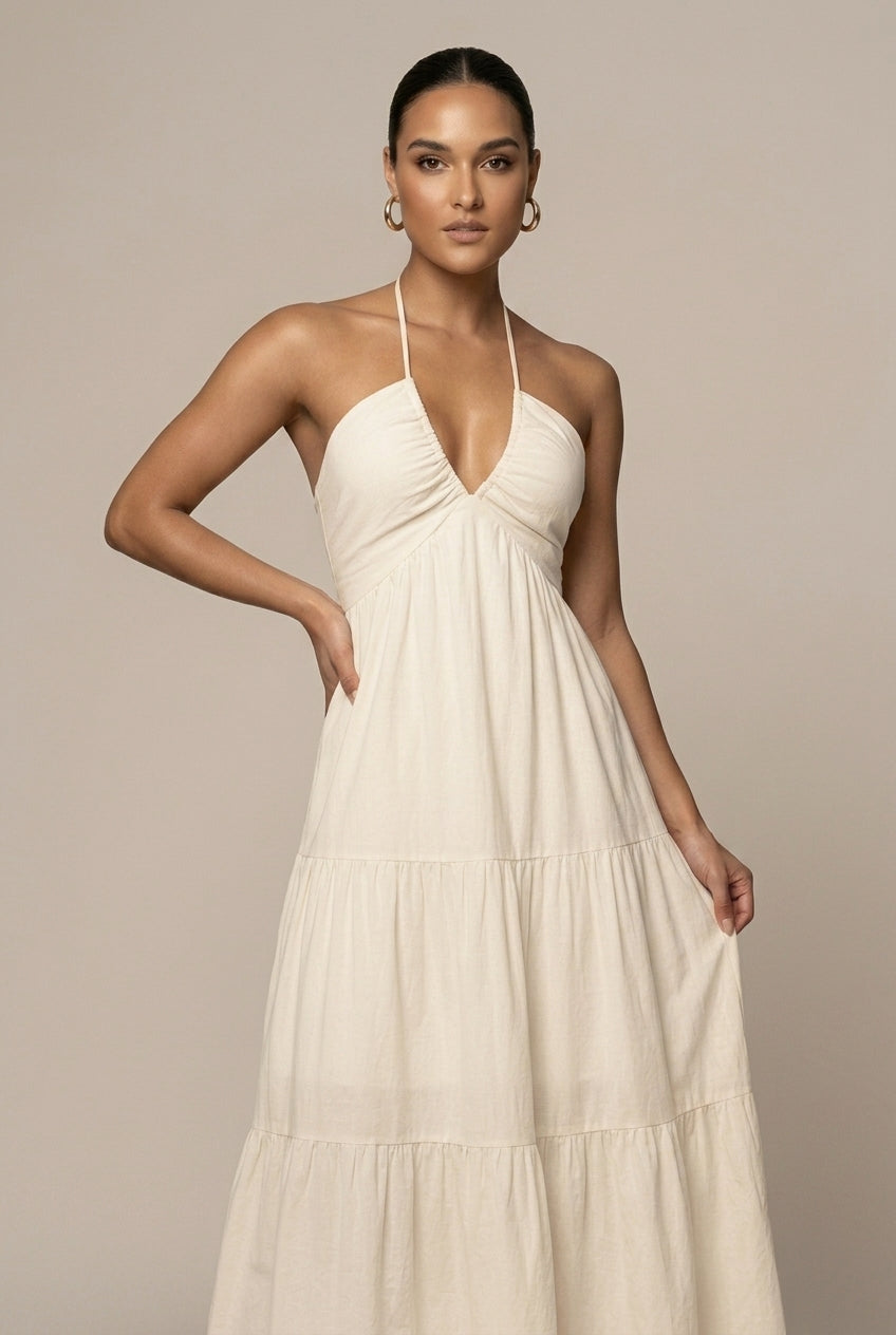 Flowy women's open back maxi dress, halter neck design, tiered ruffles, and an elegant tie waist.