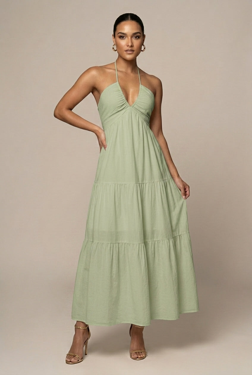 Formal women's evening gown style maxi dress, halter neck, tiered ruffle skirt, and open back detail.