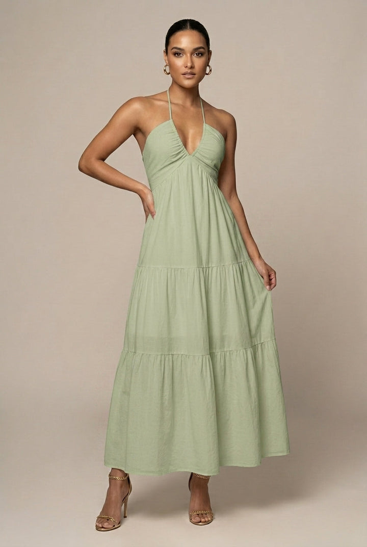 Formal women's evening gown style maxi dress, halter neck, tiered ruffle skirt, and open back detail.