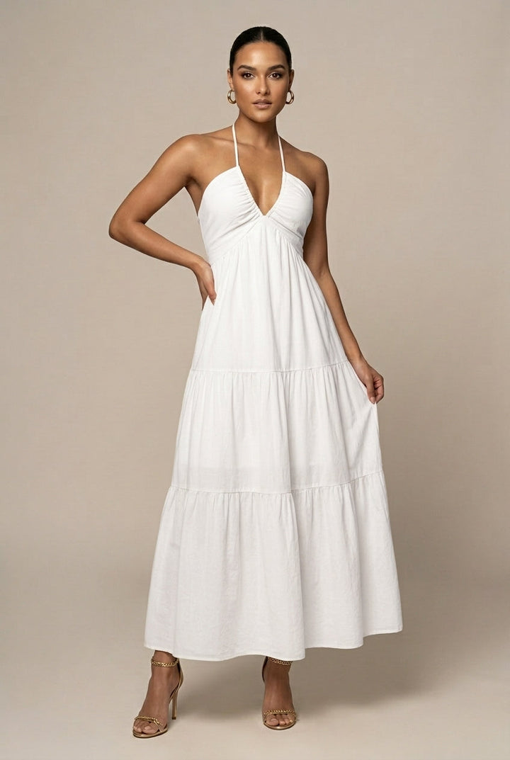 Vibrant women's party maxi dress with halter neck, tiered ruffle skirt, and open back tie waist.
