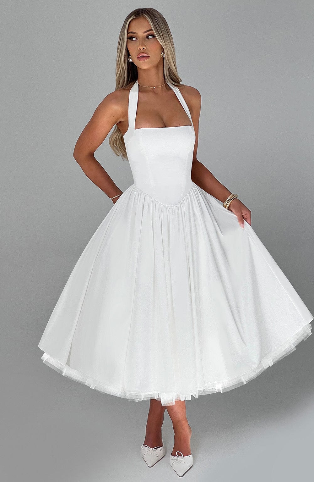 Women's sophisticated cocktail dress, halter neck and midi length.