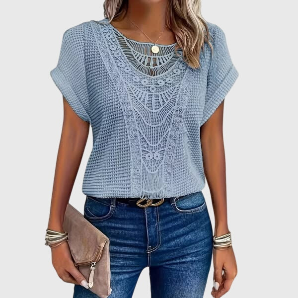 Women's elegant Ibiza blouse with intricate lace details, a stylish and breathable summer top.