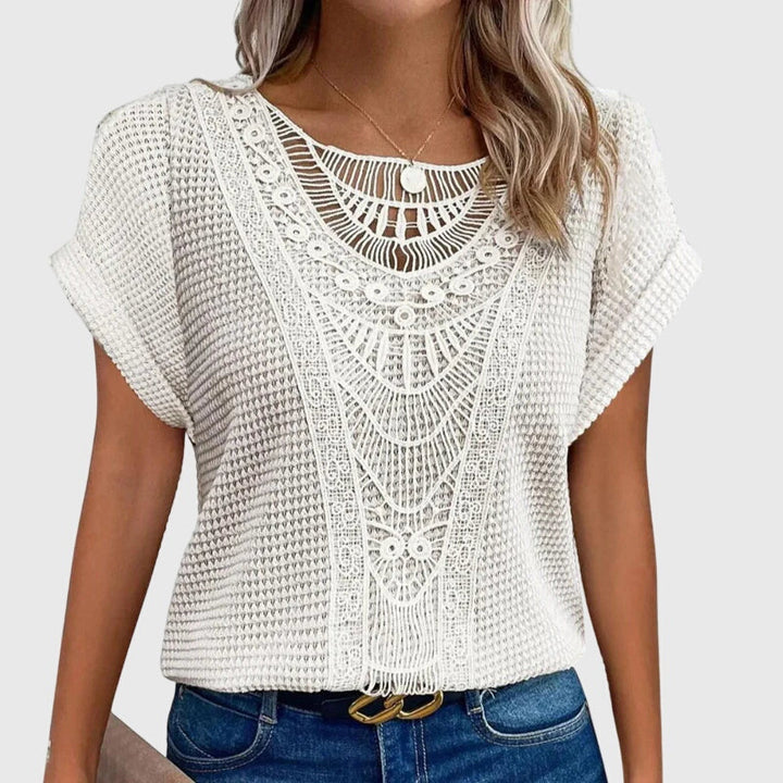Woman wearing an elegant Ibiza style lace blouse, perfect chic summer fashion.