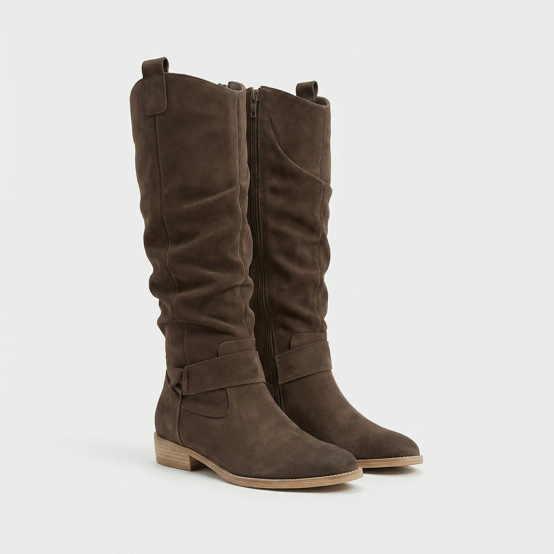 Elegant Chantal knee-high boots for women. Block heel, side zipper, and bow detail offer chic fall/winter style.