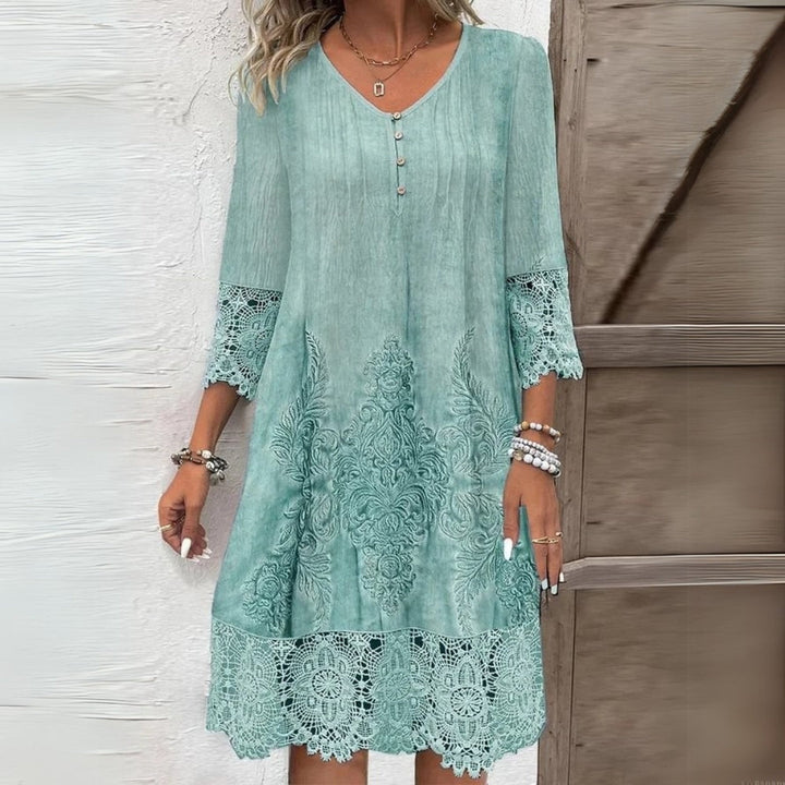 Feminine women's shift midi dress featuring delicate lace details & comfortable three-quarter sleeves, for day wear.