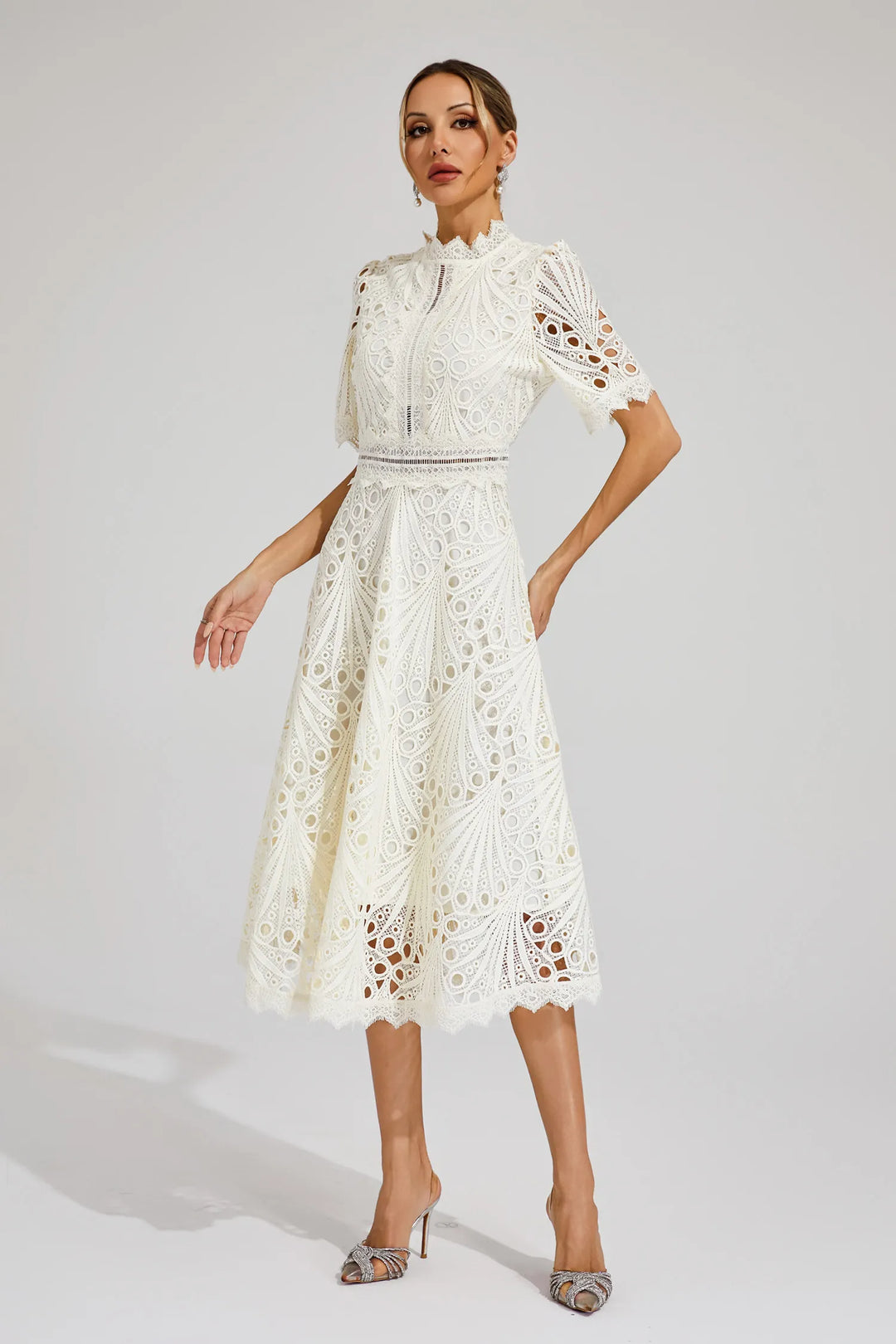 Full-length view: Elegant women's lace midi dress. Perfect wedding guest or special occasion attire.