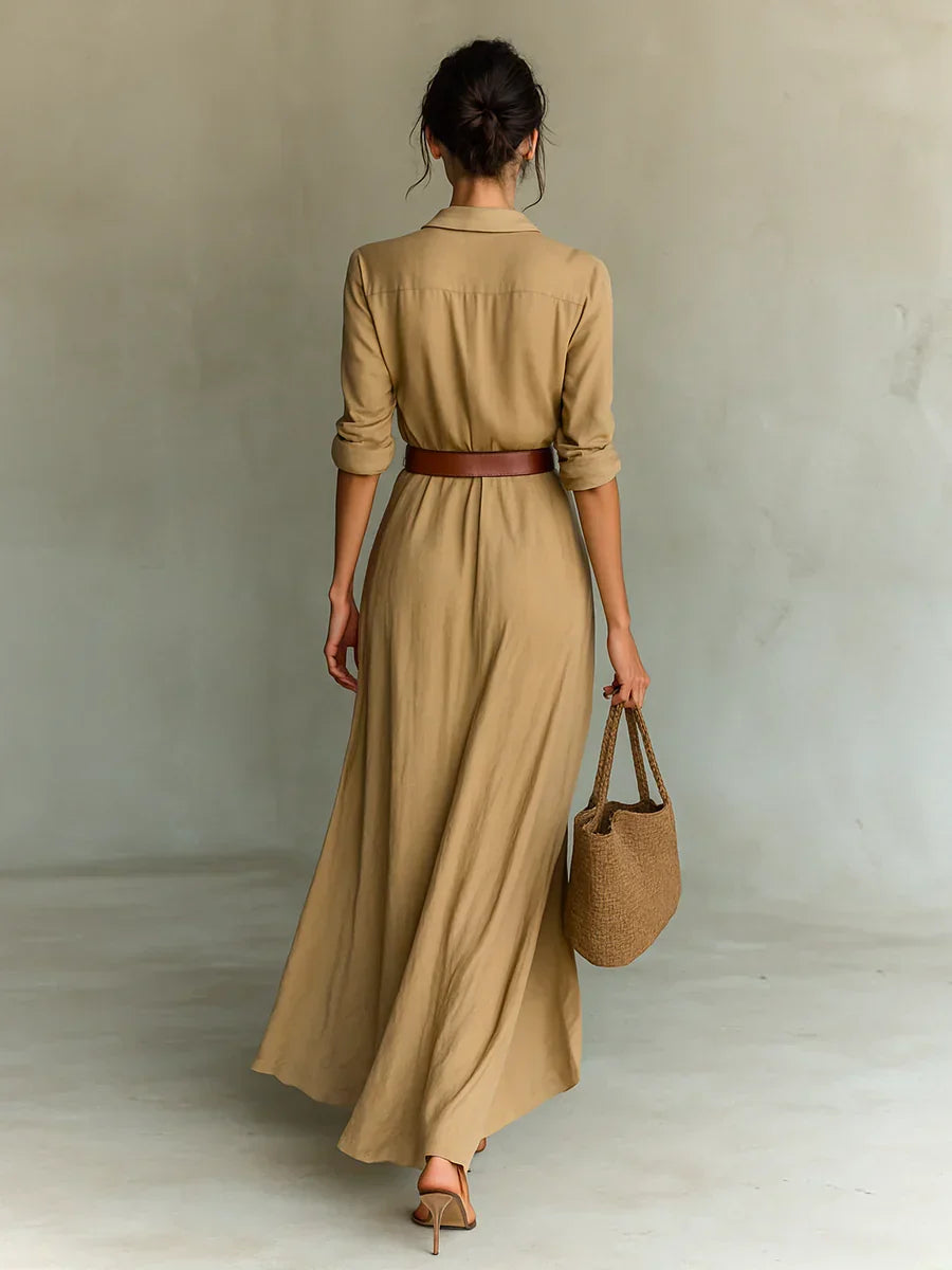 Sophisticated women's belted maxi dress featuring a lapel collar & long sleeves, ideal for elegant occasions.