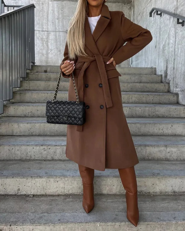 Tailored women's long trench coat with an elegant belt, offering a structured fit for office & classic style.