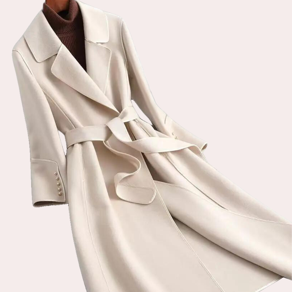 Close-up of a women's long coat showing elegant double buttons and the detailed self-tie belted waist.
