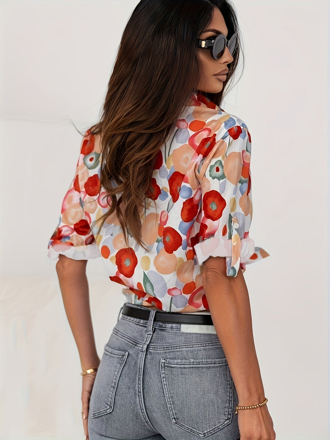 Vibrant floral print women's long-sleeve button-down blouse, artistic design for casual or smart casual.