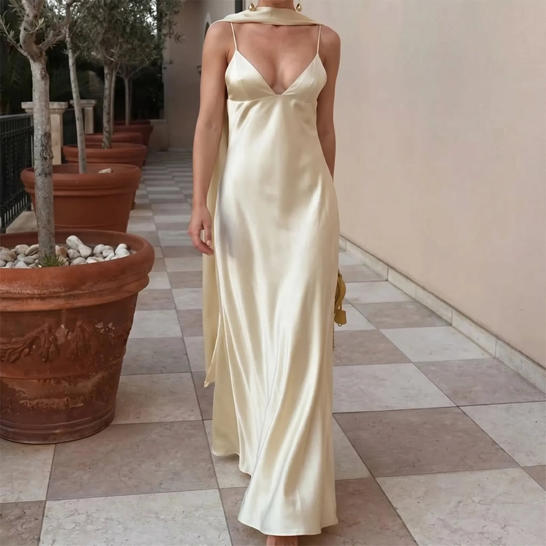 Elegant women's long slip dress with open back, V-neck, and scarf detail, perfect for evening or special occasions.