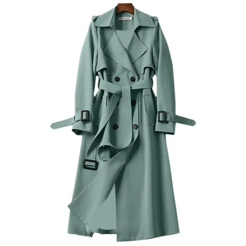 Sophisticated long trench coat for women. Double-breasted closure & adjustable tie belt. Classic fall outerwear.