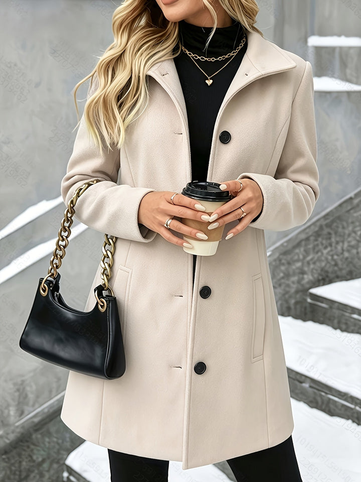 Black women's elegant longline winter coat with notch collar. A classic cold weather layering piece.