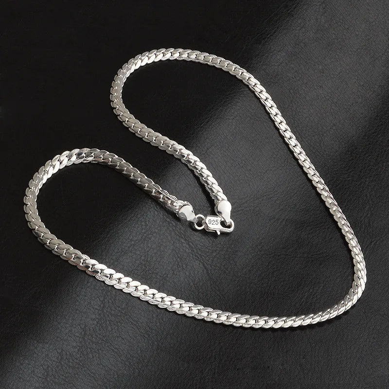 Detailed view of the shimmering lucky charm pendant on an elegant women's necklace, a beautiful gift for her.