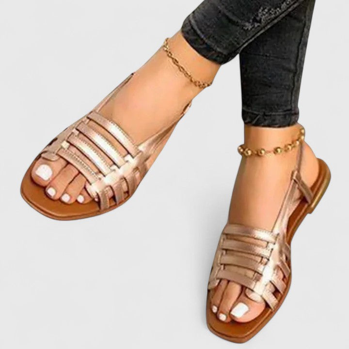 Comfortable women's flat sandals feature metallic woven straps, open toe design & slingback for effortless summer boho style.