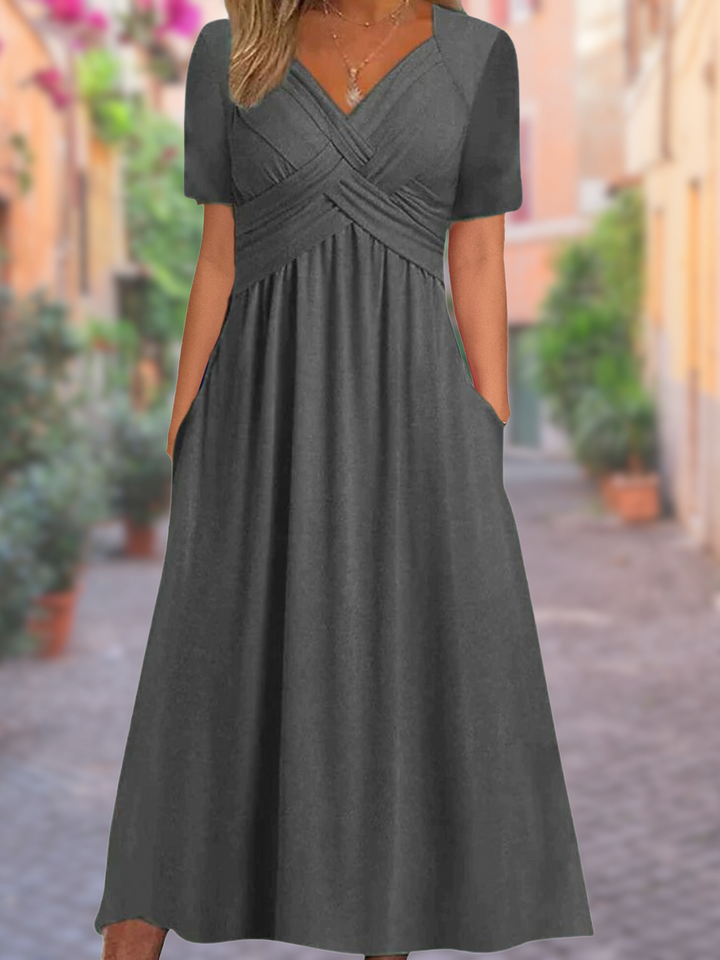 Close-up of the V-neck crisscross bodice on an elegant women's midi dress, highlighting chic detail.