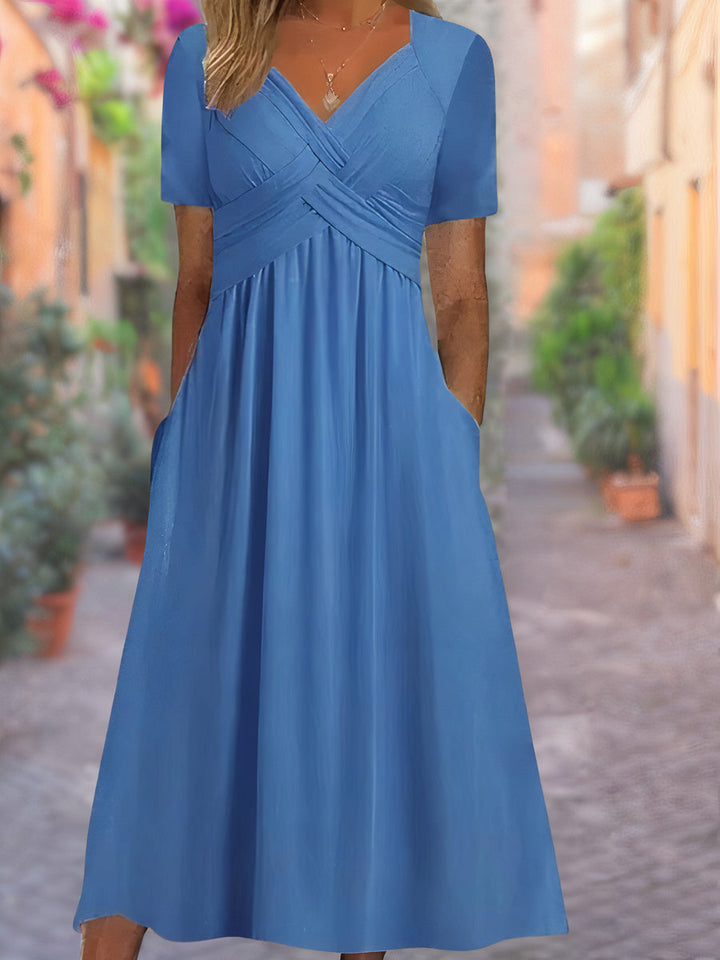 Versatile women's V-neck midi dress with crisscross detail, suitable as an elegant cocktail or everyday dress.