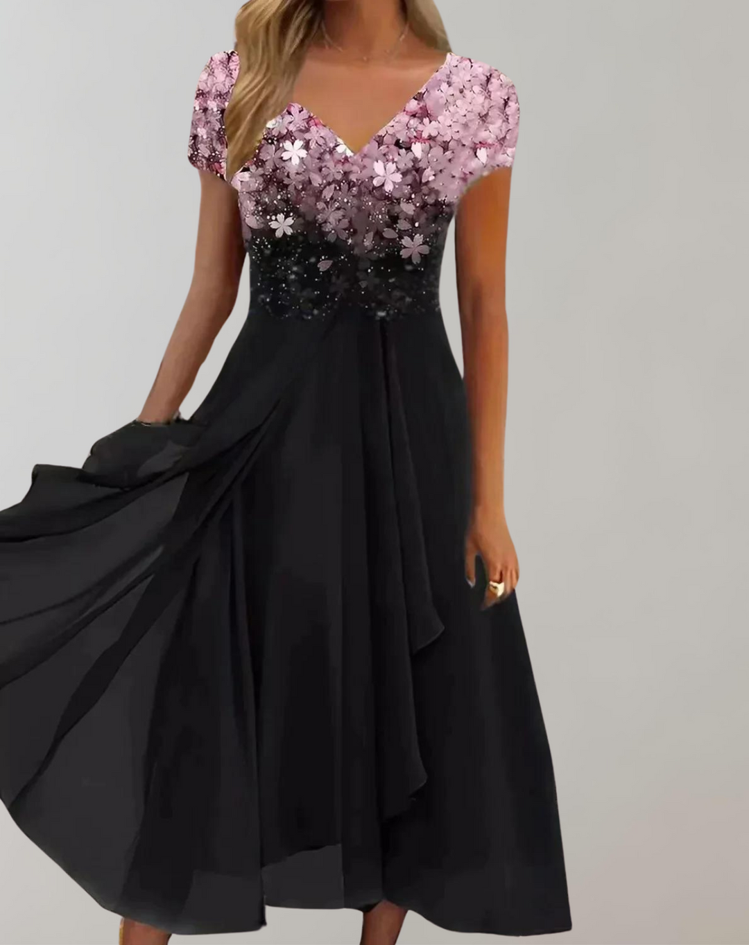 Close-up of the glamorous floral embellished bodice on an elegant women's cocktail party midi dress.