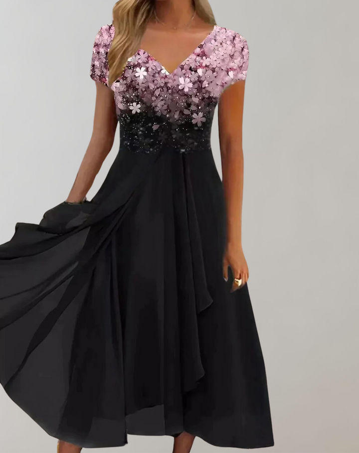 Close-up of the glamorous floral embellished bodice on an elegant women's cocktail party midi dress.