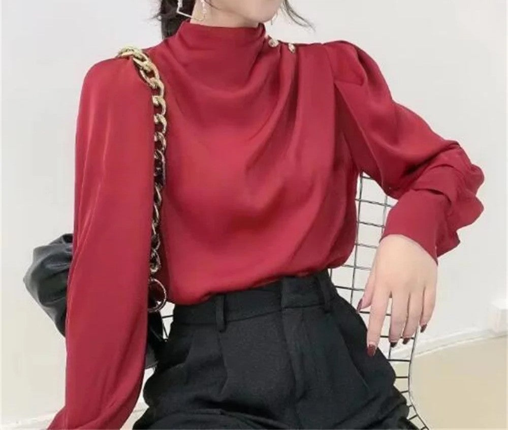 Chic women's mock neck blouse with flattering ruching, long sleeves, and classy gold buttons for sophisticated wear.