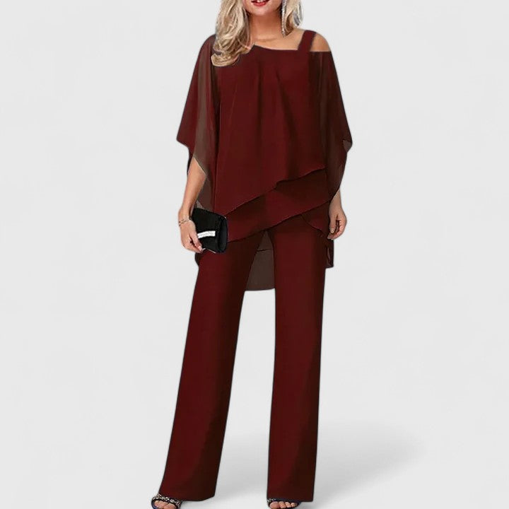 Elegant women's off-shoulder two-piece formal set with a cape top and wide-leg pants. Perfect for evening.