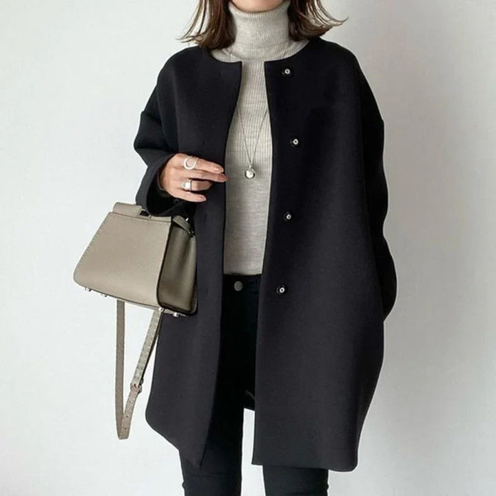 Elegant women's oversized black button coat, perfect for winter and fall minimalist fashion.