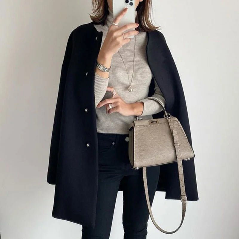 Minimalist women's oversized winter coat with buttons, an elegant fall jacket for versatile styling.